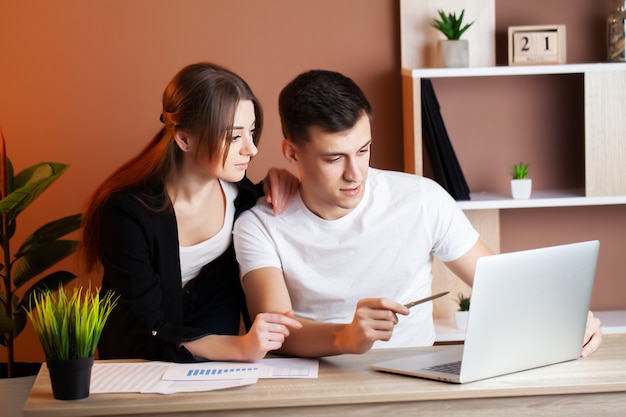 Loving couple working successfully together on their own business