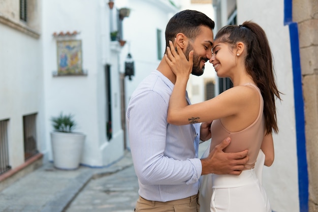 Loving ethnic couple embracing in city