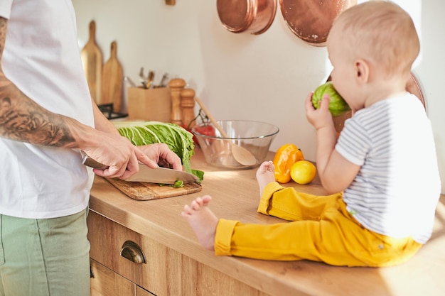 Loving father cooks with his son in the kitchen at home