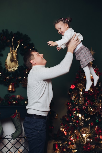 Loving father playing with his daughter at Christmas.