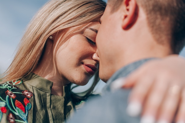 Loving guy and girl kisses in nature. love story outdoor.Lovers Walking in spring park.portrait emotional couple walking outdoors in sunny day in spring.