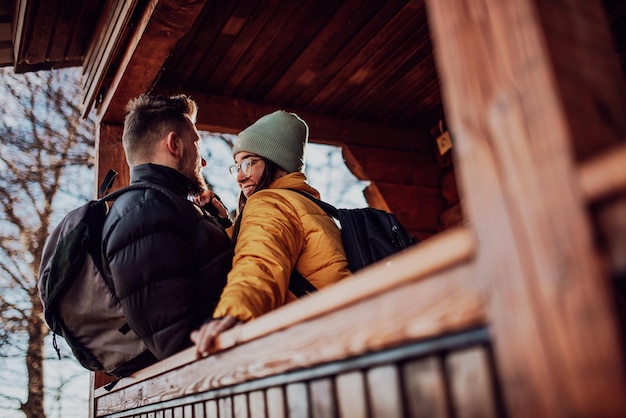 Loving man and woman standing in their cottage room balcony