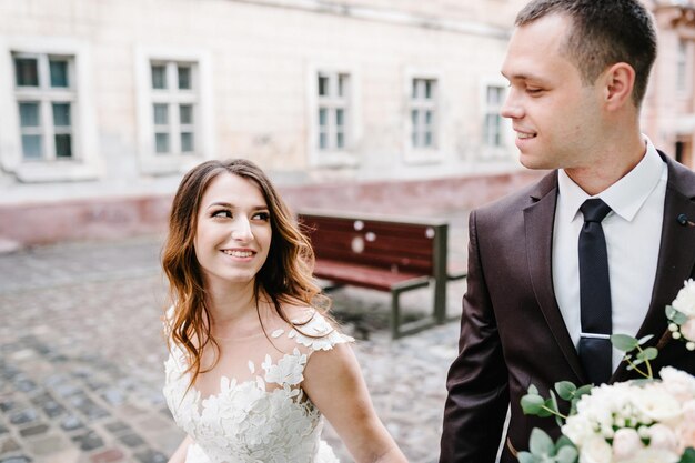 A loving wedding couple are walking along the streets of the city of Lviv. Newlyweds are walking. Wedding walks.