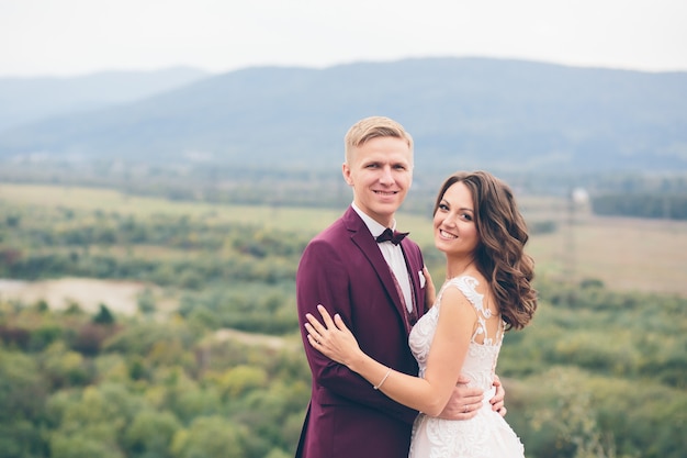 Loving wedding couple in the mountains