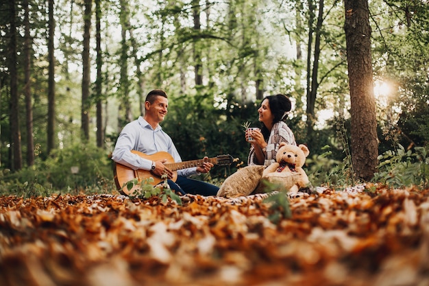 Loving young couple enjoying the outdoors, autumn, blurred