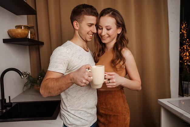 Loving young couple hugging in the kitchen