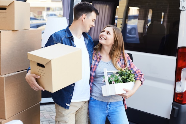 Loving Young Couple with Cardboard Boxes