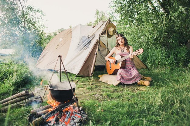 Loving young sexy coupl near camp tent Camping couple in love Couples of lovers tourists relax on nature Camping trip with lovers Carefree coupl near campfire bonfire freedom concept