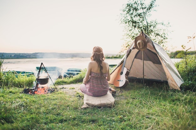 Loving young sexy coupl near camp tent Camping couple in love Couples of lovers tourists relax on nature Camping trip with lovers Carefree coupl near campfire bonfire freedom concept