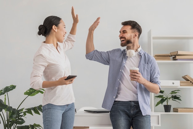 Low angle celebrating success with high five