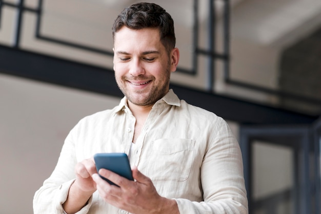 Low angle man holding smartphone