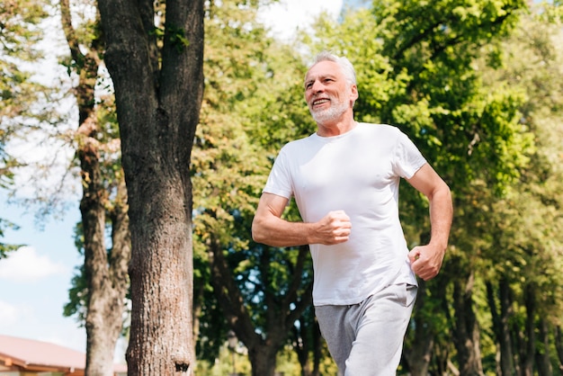 Low angle old man running outdoors