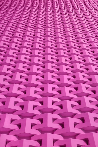 Low angle of orchid pink colored wall 3D pattern surface