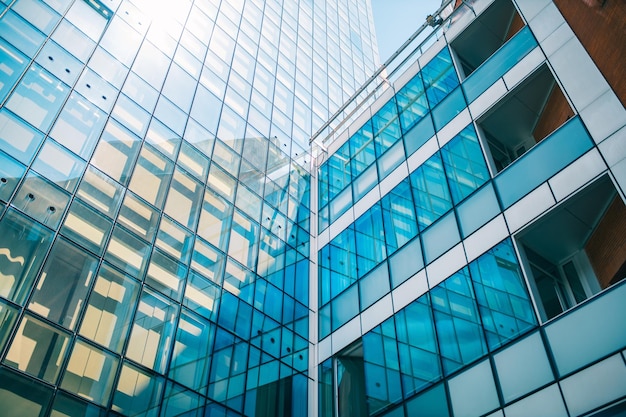 Low angle shot of a business building with glass walls under the sunlight