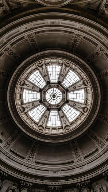 Low angle shot of a round ceiling with a window in a museum in vatican during daytime