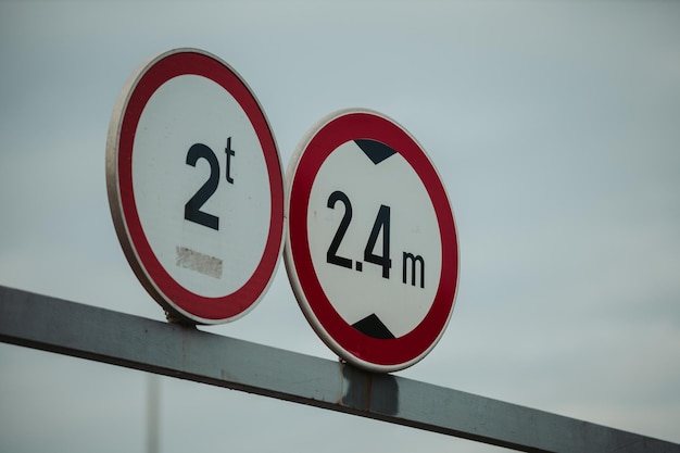 Low angle shot of weight control and height restriction road signs