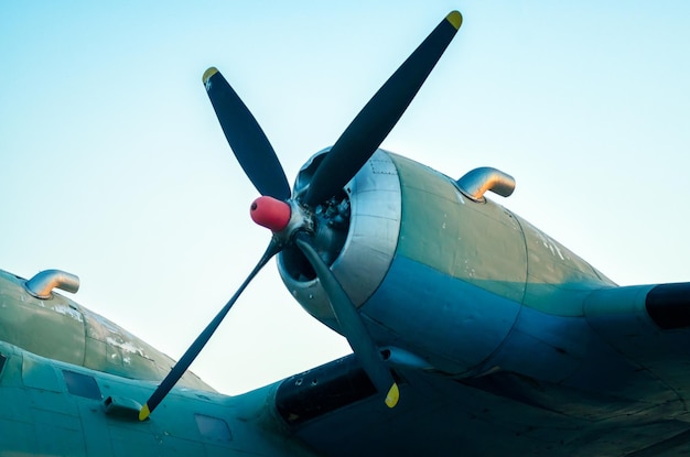 Low angle view of airplane flying against clear blue sky