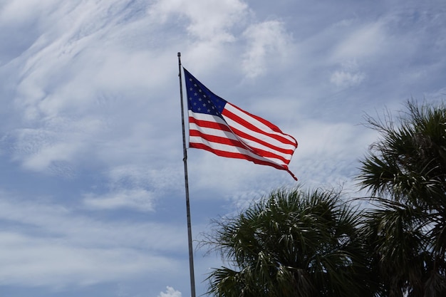 Low angle view of american flag against sky