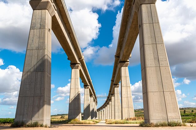 Low angle view of bridge against cloudy sky