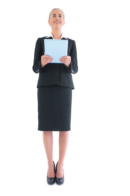 Low angle view of cheerful attractive businesswoman holding her tablet