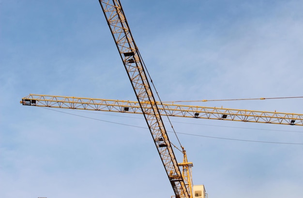 Low angle view of crane against sky