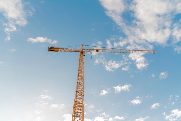 Low angle view of crane against sky