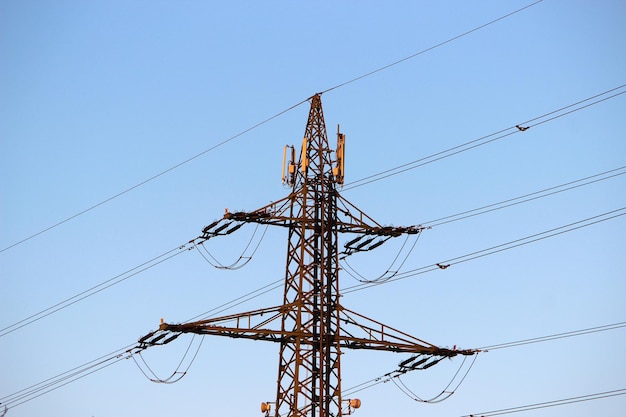 Low angle view of electricity pylon against clear sky