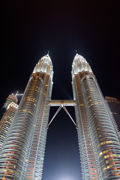 Low Angle View Of The Famous Petronas Towers At Night In Kuala Lumpur, Malaysia Vertical Shot