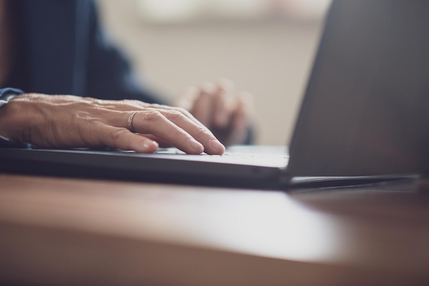 Low angle view of female hand using laptop computer