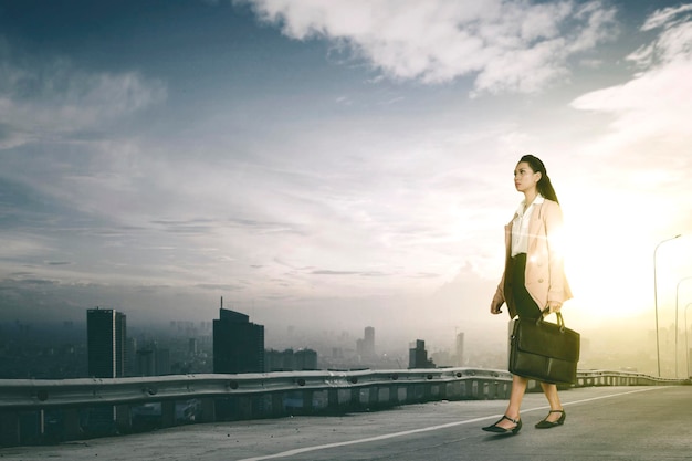 Low angle view of female manager walking on road