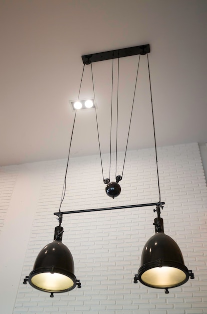 Low angle view of illuminated pendant light hanging on ceiling