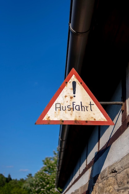 Low angle view of information sign against clear blue sky