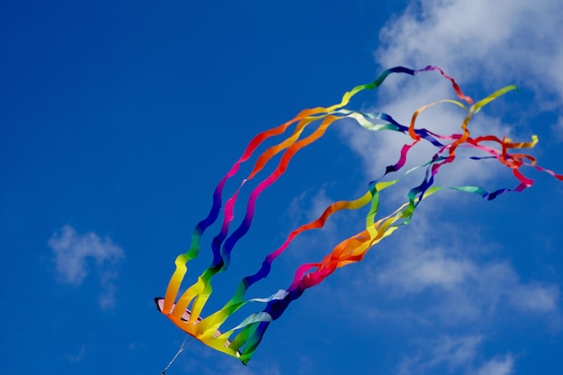 Low angle view of kite flying against blue sky