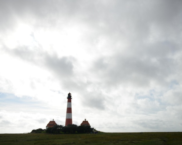 Low angle view of lighthouse against cloudy sky