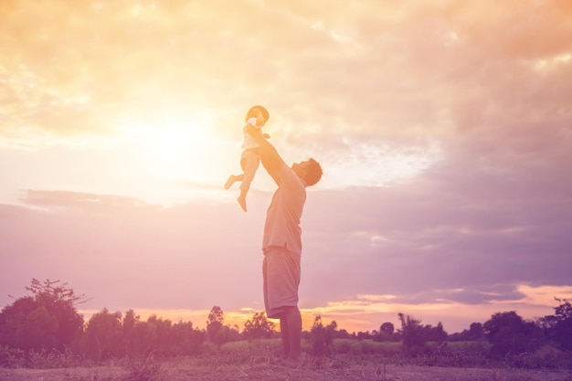 Low angle view of man standing on field against sky during sunset