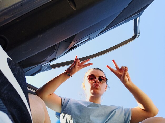 Photo low angle view of man wearing sunglasses against sky