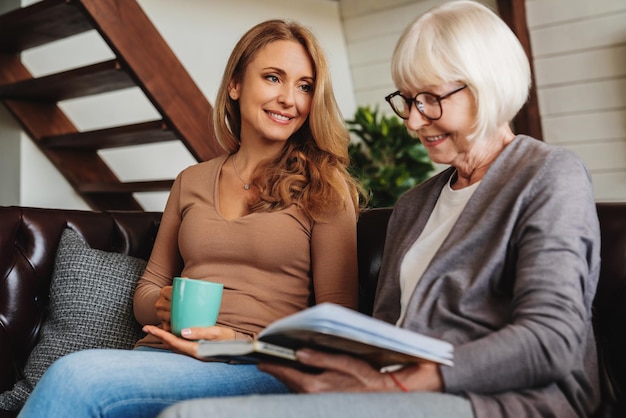 Low angle view of middle aged woman spending time with her senior mother at home