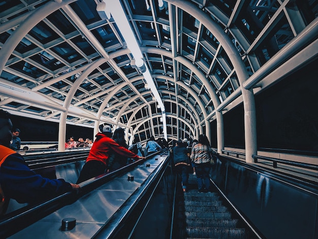 Photo low angle view of people standing in elevator