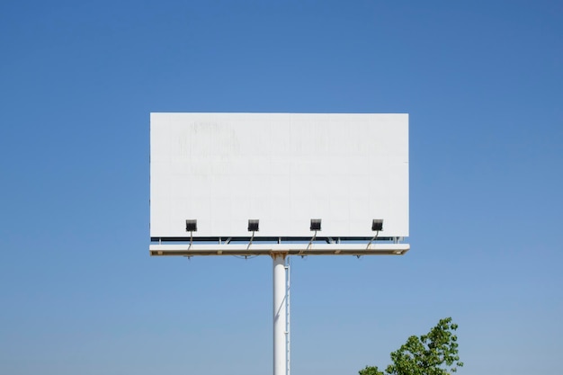 Low angle view of sign against clear blue sky