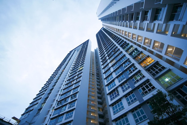 Low angle view of signapore residential buildings against blue sky