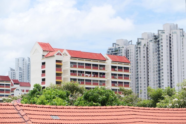 Low angle view of signapore residential buildings against blue sky