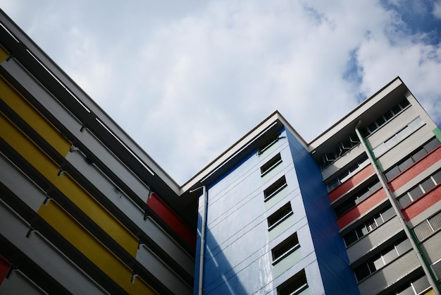 Low angle view of signapore residential buildings against blue sky