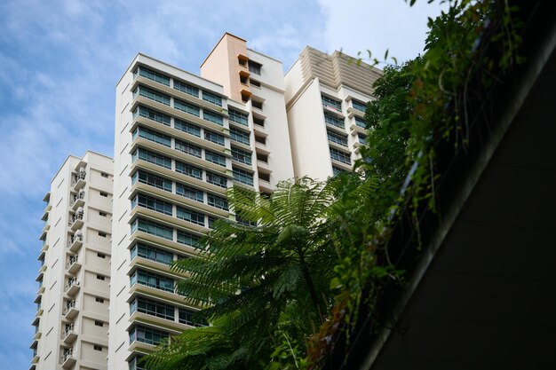 Low angle view of signapore residential buildings against blue sky