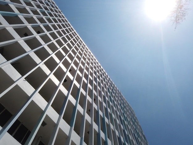 Low angle view of singapore residential buildings against blue sky