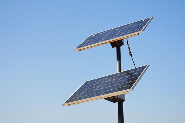 Low angle view of Solar panel against blue sky