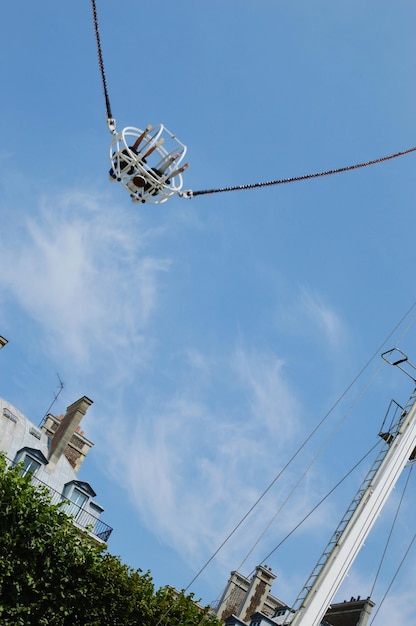 Low angle view of swing at amusement park