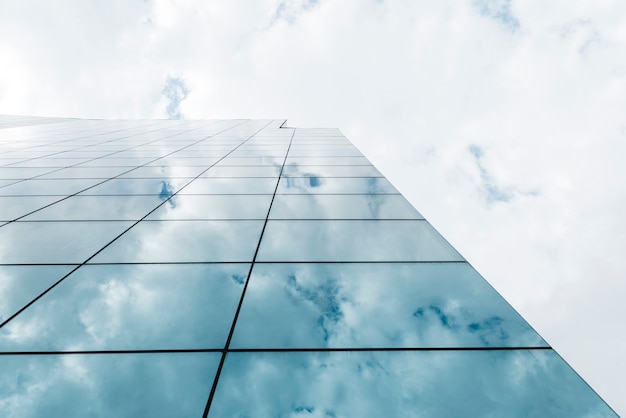 Low angle view tall building and clouds