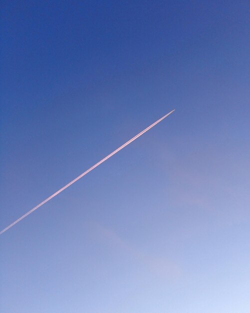 Low angle view of vapor trail in blue sky