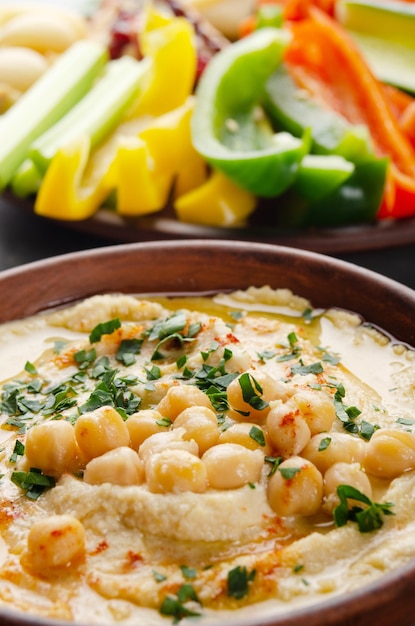 Low angle view at vegetable Hummus dip dish topped with chickpeas and olive oil