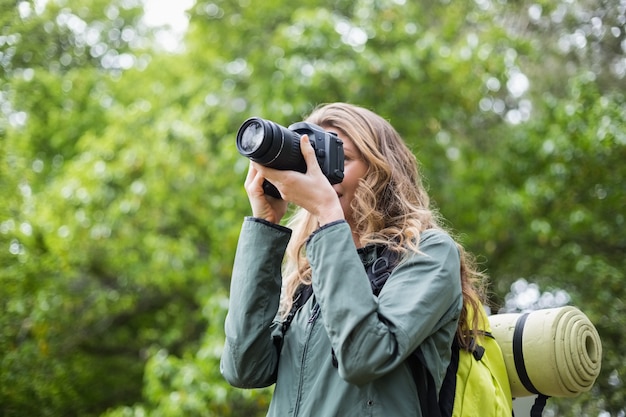 Low angle view of woman photographing with camera 